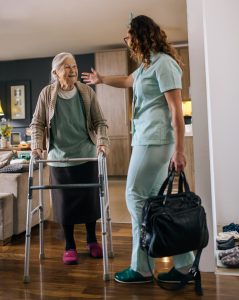 a nurse visits an elderly disabled woman at home and helps her Tucson Senior Living Facility