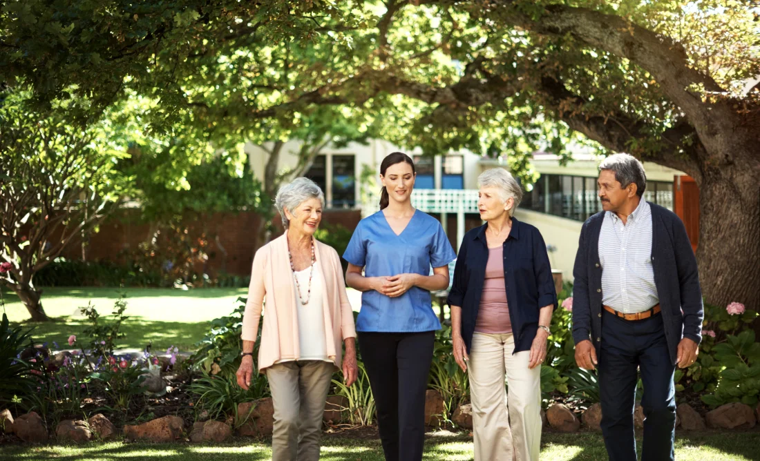 Visitors and residents walking through an assisted living community during an open house tour